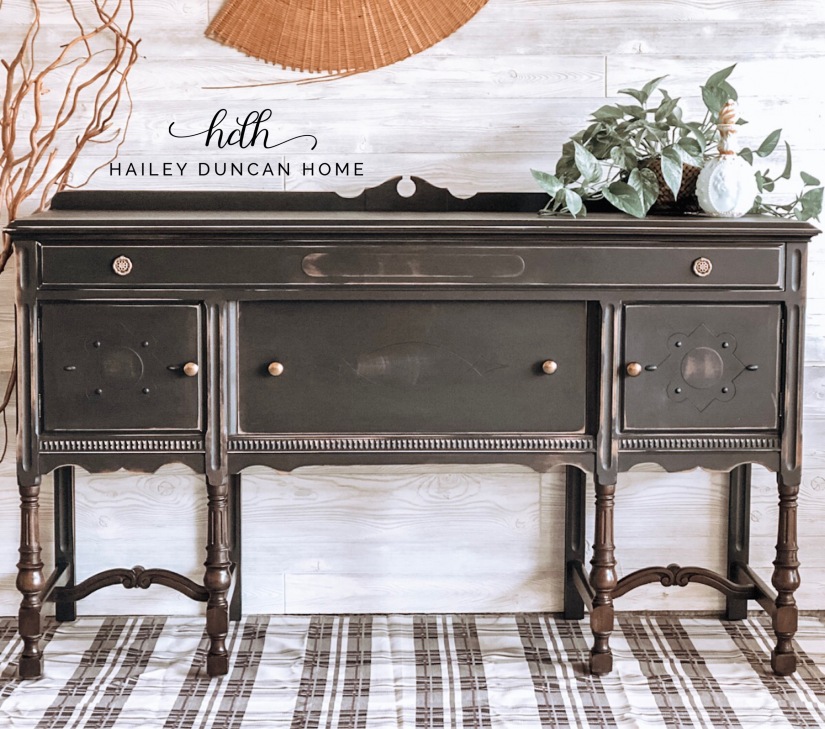 Painted vintage black buffet with stained legs.