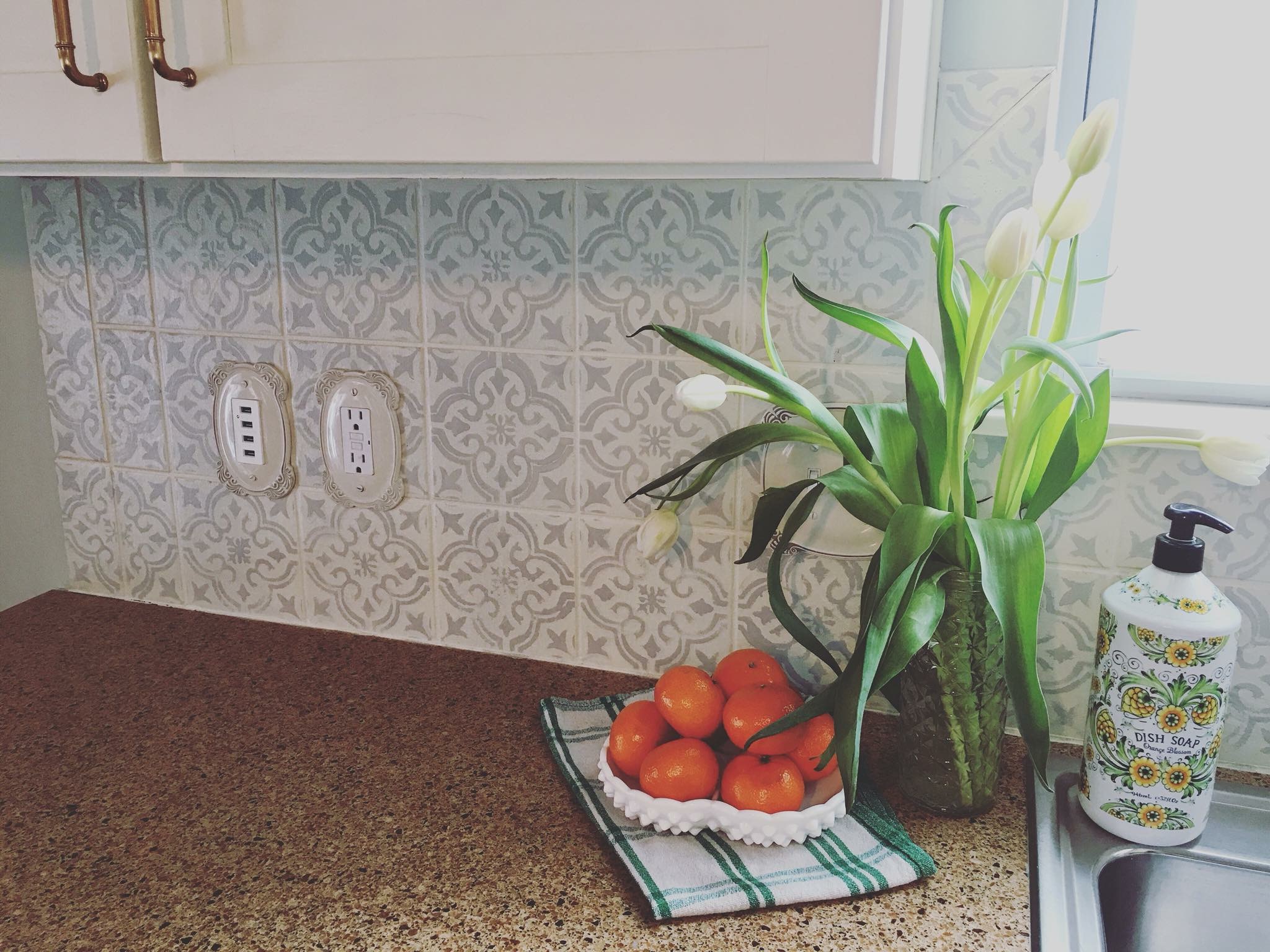 How to Paint and Stencil Your Tile Backsplash. This is a budget friendly kitchen update!
